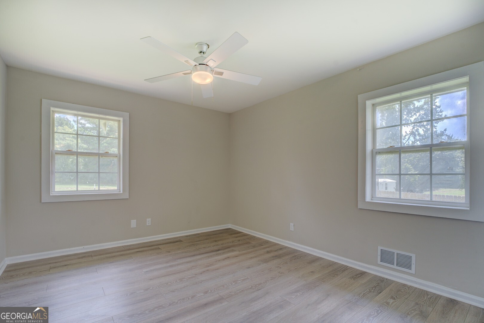 635 Jackson Lake Road Mansfield, GA 30055 - Photo 40 of 68 a view of an empty room with wooden floor and a window