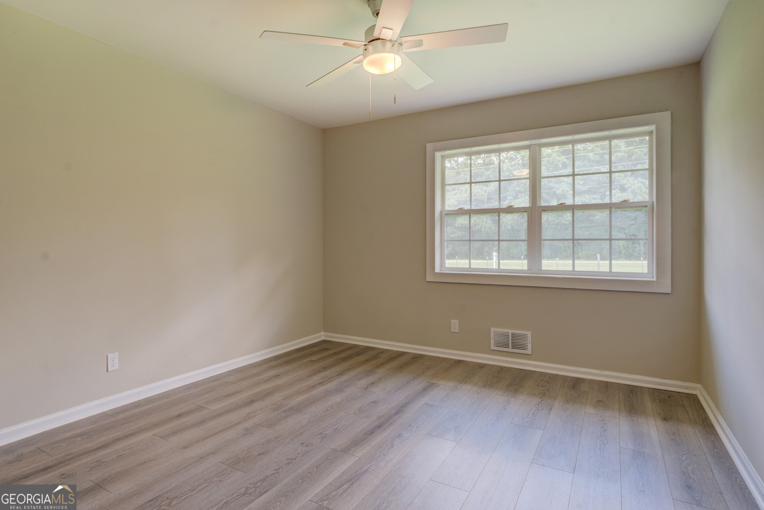 635 Jackson Lake Road Mansfield, GA 30055 - Photo 44 of 68 wooden floor in an empty room with a window