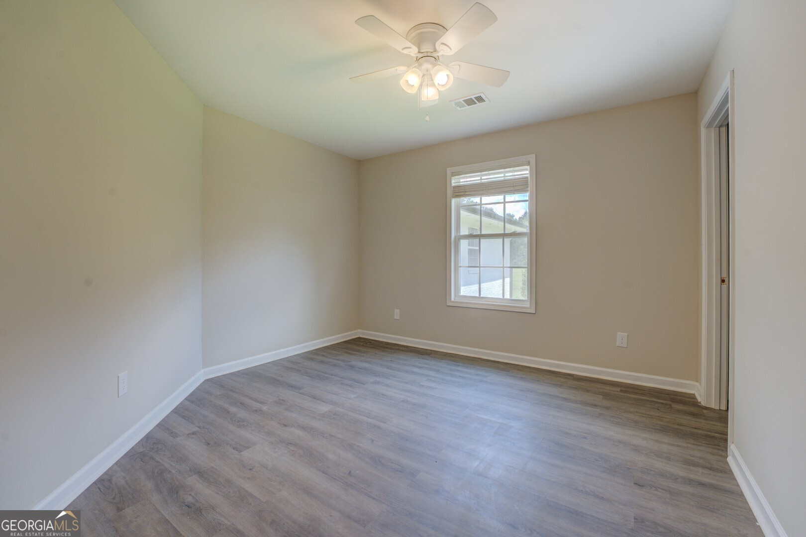 635 Jackson Lake Road Mansfield, GA 30055 - Photo 45 of 68 a view of an empty room with a window and wooden floor