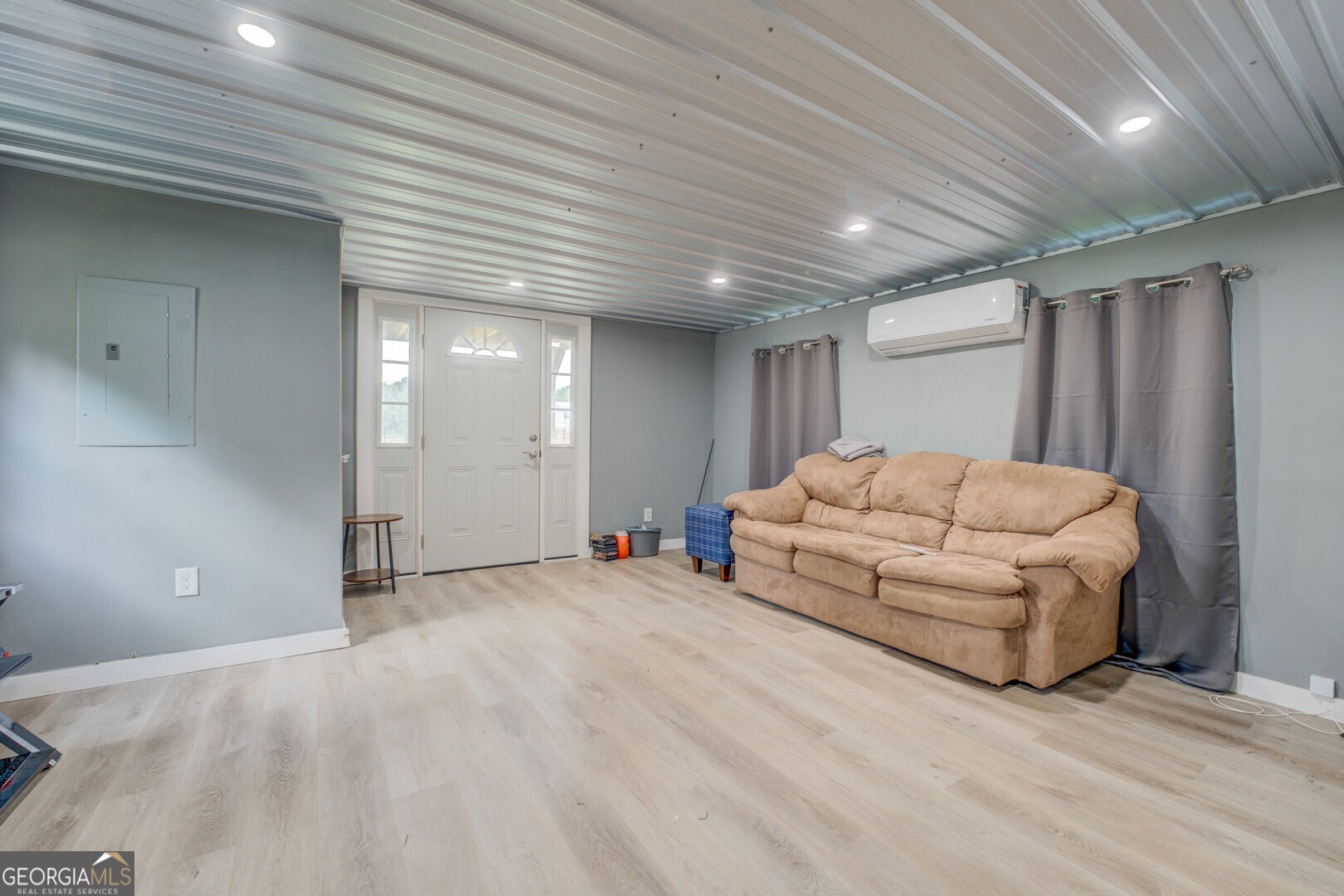 635 Jackson Lake Road Mansfield, GA 30055 - Photo 49 of 68 a living room with furniture and a chandelier