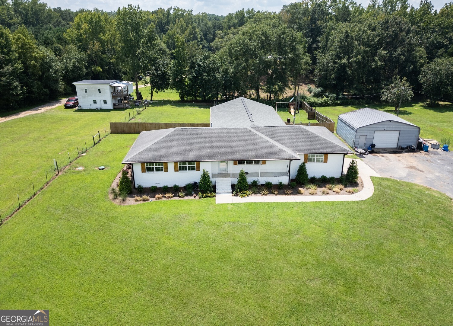 635 Jackson Lake Road Mansfield, GA 30055 - Photo 5 of 68 a aerial view of a house with backyard outdoor seating and trees