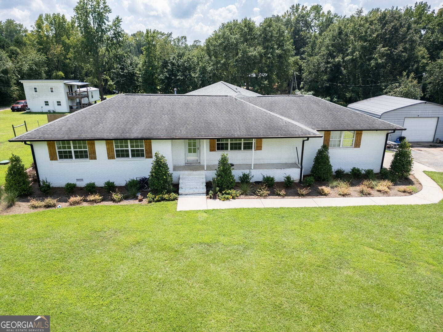 635 Jackson Lake Road Mansfield, GA 30055 - Photo 6 of 68 a front view of a house with a yard and garage