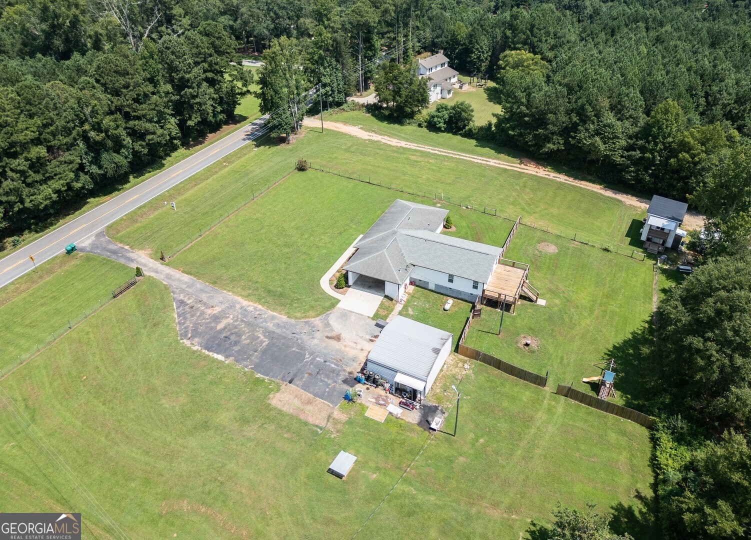 635 Jackson Lake Road Mansfield, GA 30055 - Photo 61 of 68 an aerial view of a house with a swimming pool