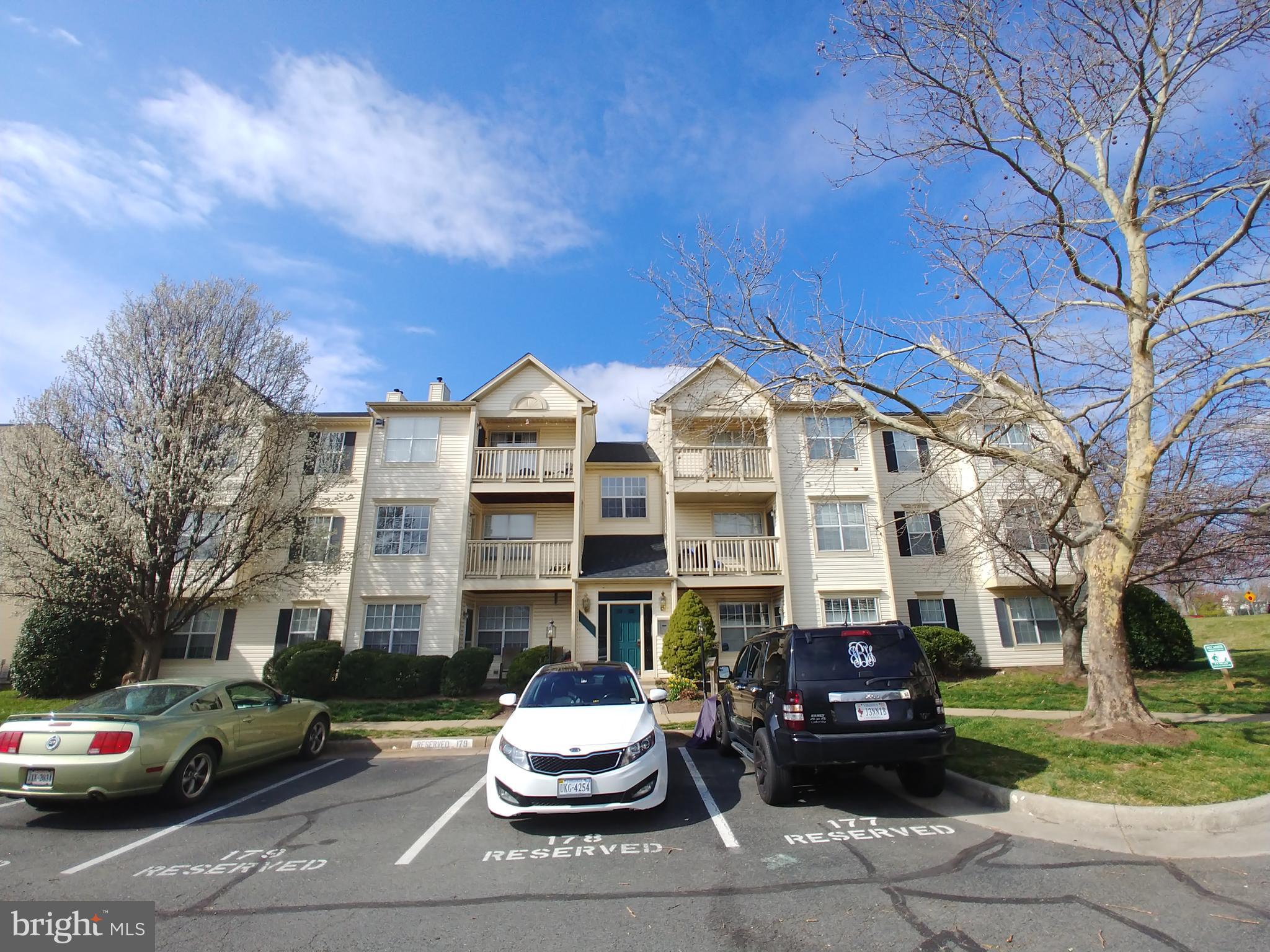 11002 Koman Circle, Unit 303 Manassas, VA 20109 - Photo 1 of 14 a view of a parked cars in front of a building
