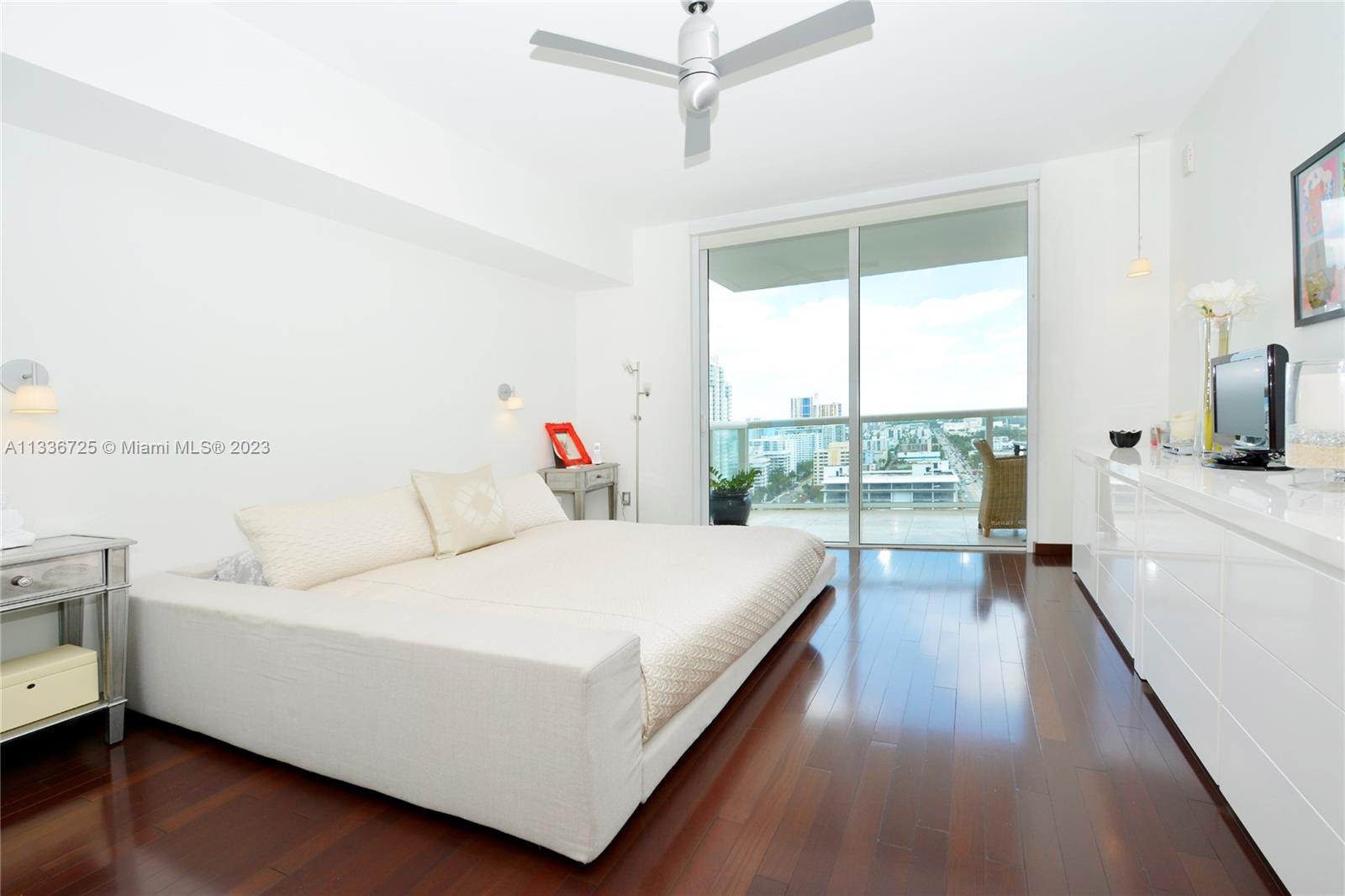 450 Alton Road, Unit 2006 Miami Beach, FL 33139 - Photo 11 of 34 a bed room with a bed and a large window