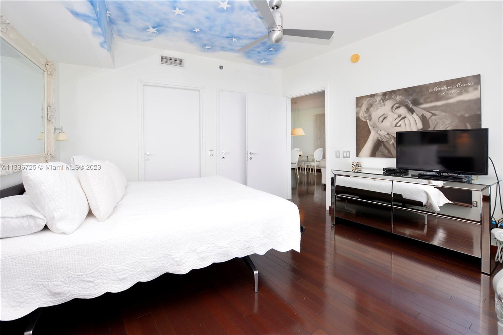 450 Alton Road, Unit 2006 Miami Beach, FL 33139 - Photo 20 of 34 a bedroom with a bed and a flat screen tv