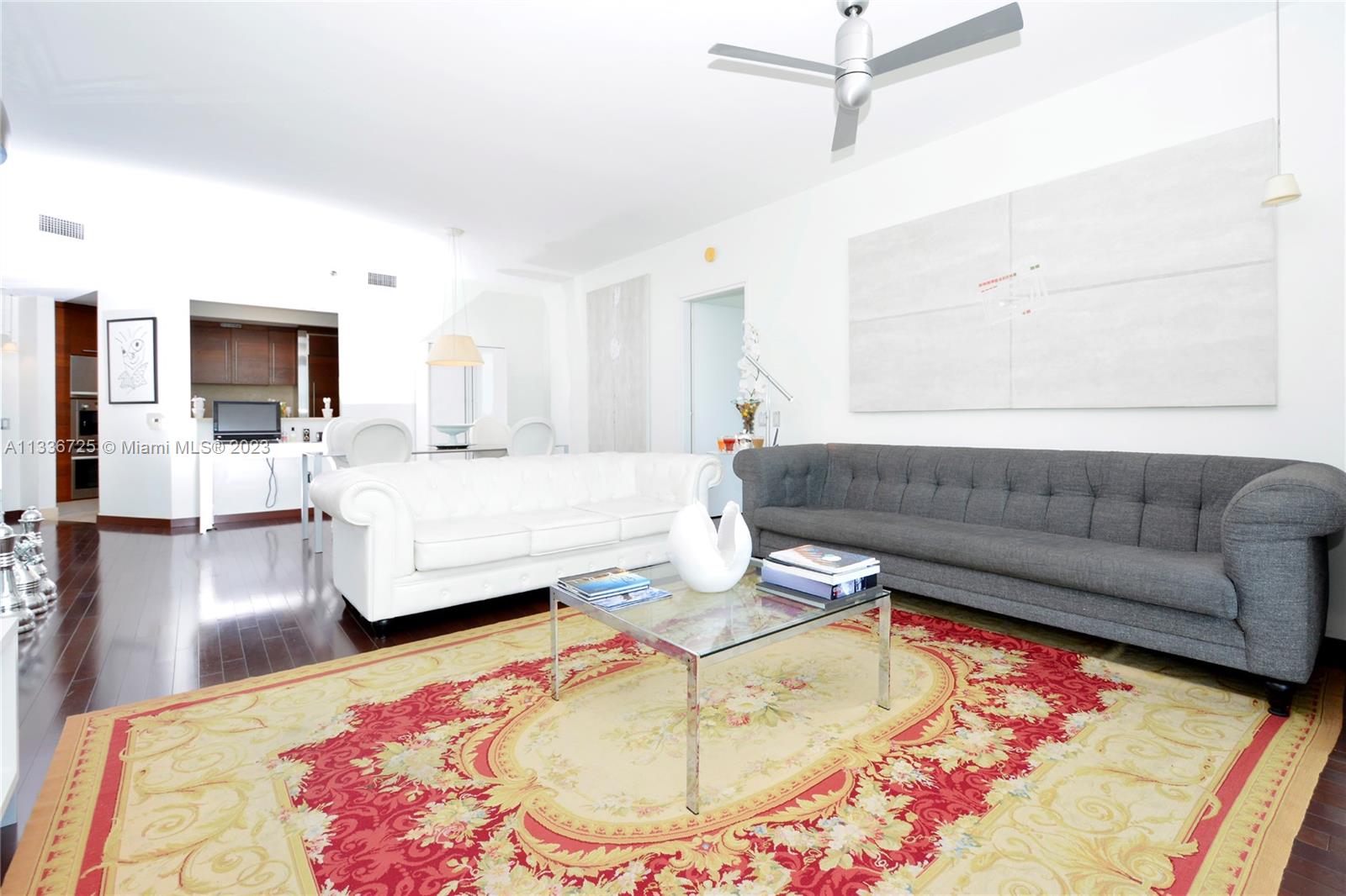 450 Alton Road, Unit 2006 Miami Beach, FL 33139 - Photo 7 of 34 a living room with furniture and a flat screen tv