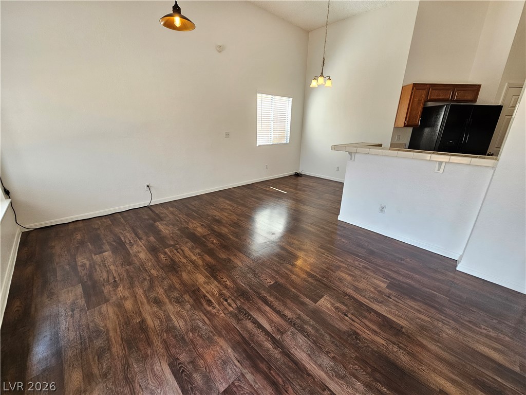2817 Albemarle Way Henderson, NV 89014 - Photo 4 of 25 Rich hardwood-style flooring extends through this airy living area, featuring high ceilings.