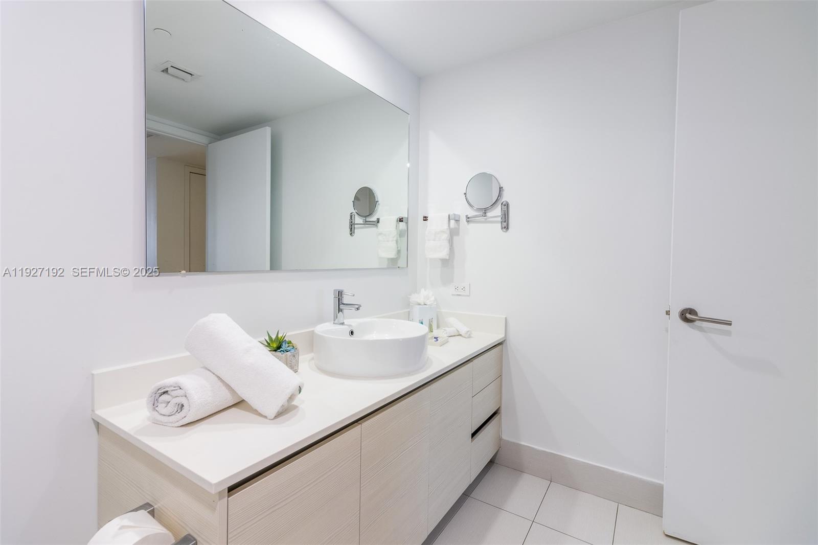 2602 East Hallandale Beach Boulevard, Unit R708 Hallandale Beach, FL 33009 - Photo 12 of 42 a bathroom with a sink and a mirror