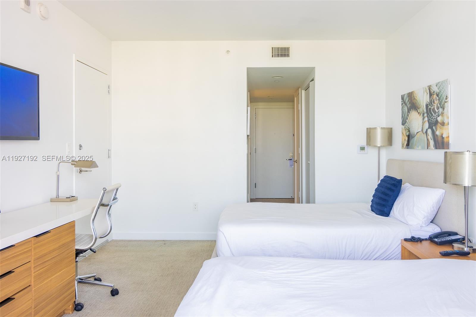 2602 East Hallandale Beach Boulevard, Unit R708 Hallandale Beach, FL 33009 - Photo 20 of 42 a bedroom with a bed and a couch