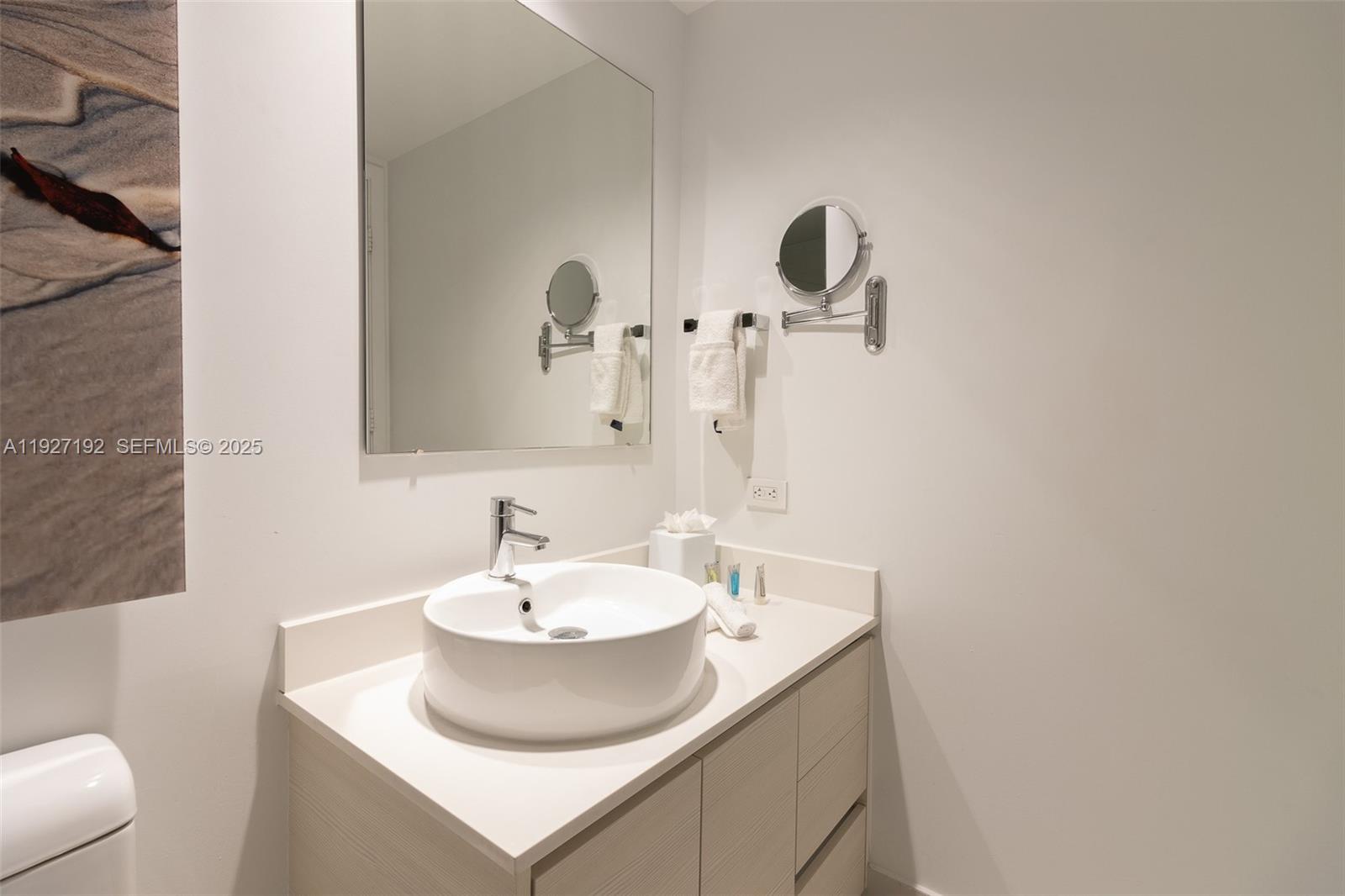 2602 East Hallandale Beach Boulevard, Unit R708 Hallandale Beach, FL 33009 - Photo 22 of 42 a bathroom with a sink and a mirror