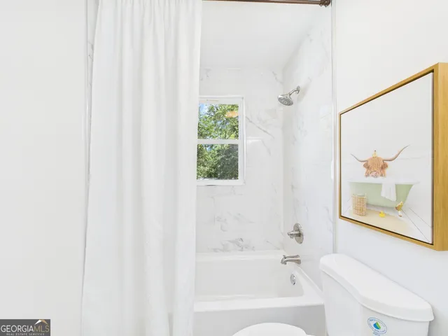 a bathroom with a sink mirror and toilet