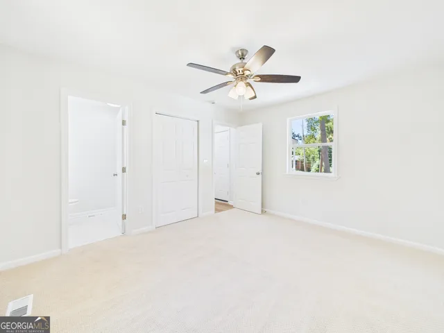 a bathroom with a sink a toilet and a window