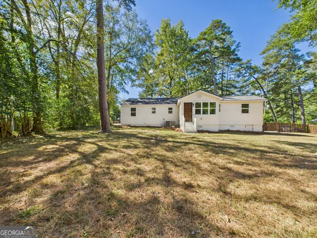 a view of a house with a tree in the background