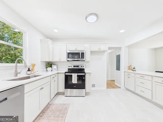a kitchen with stove cabinets and a sink
