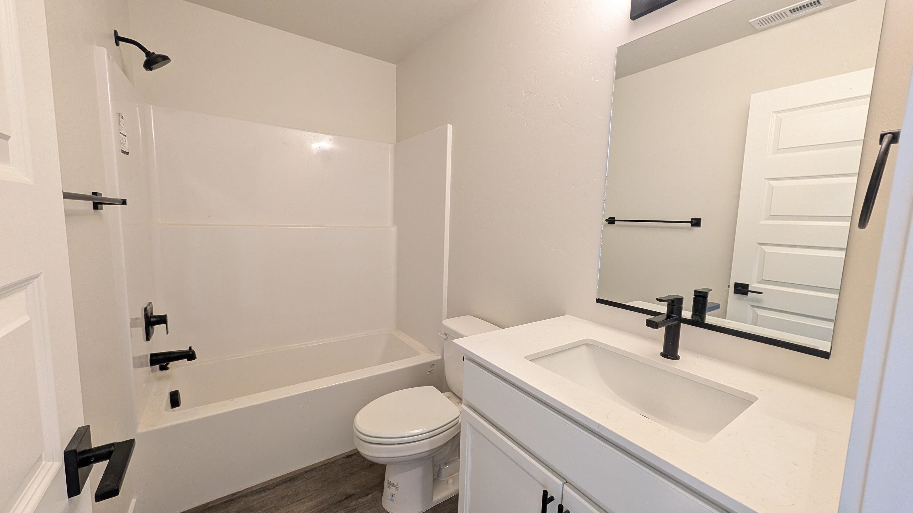 2463 Revere Road, Unit A Grand Junction, CO 81505 - Photo 7 of 13 a bathroom with a sink a toilet and shower