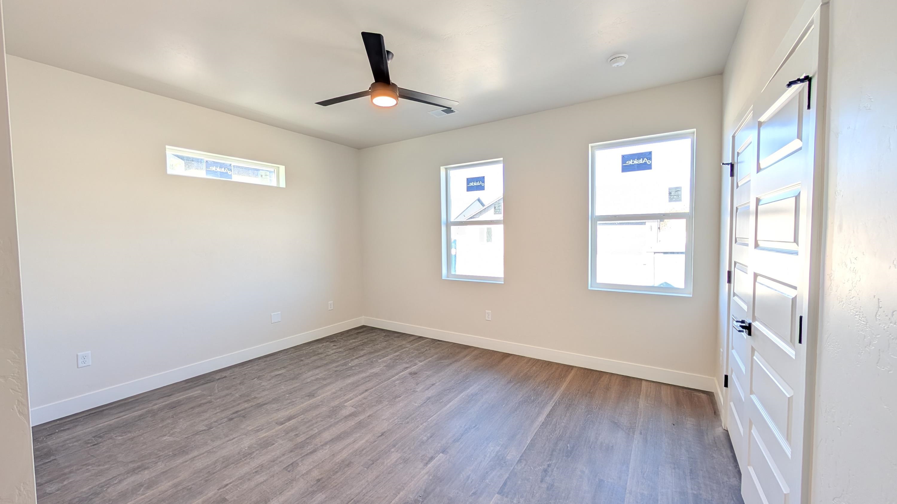 2463 Revere Road, Unit A Grand Junction, CO 81505 - Photo 8 of 13 a view of empty room with wooden floor and fan