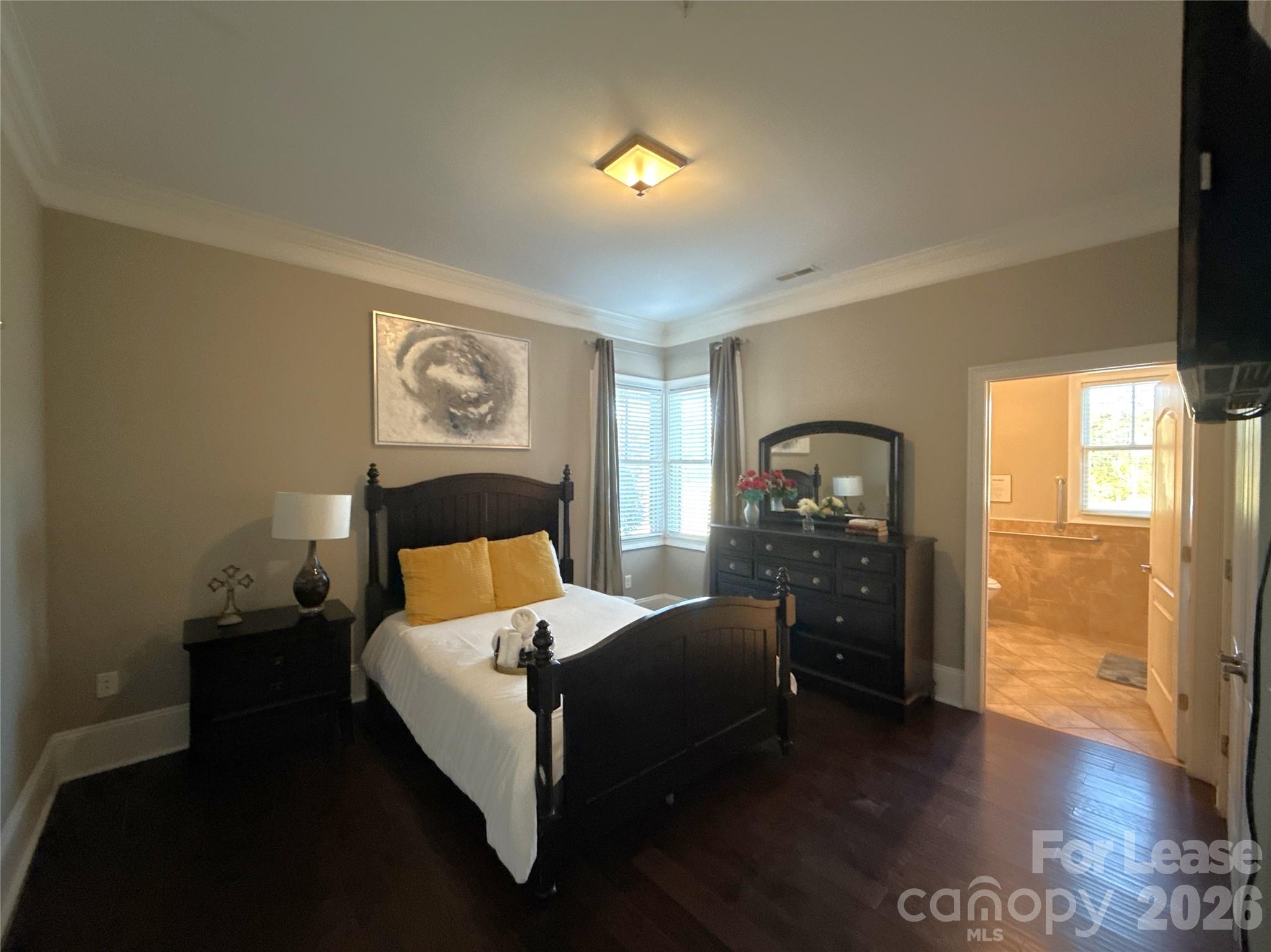 13931 Thompson Road Charlotte, NC 28227 - Photo 20 of 43 a bedroom with a bed and wooden floor