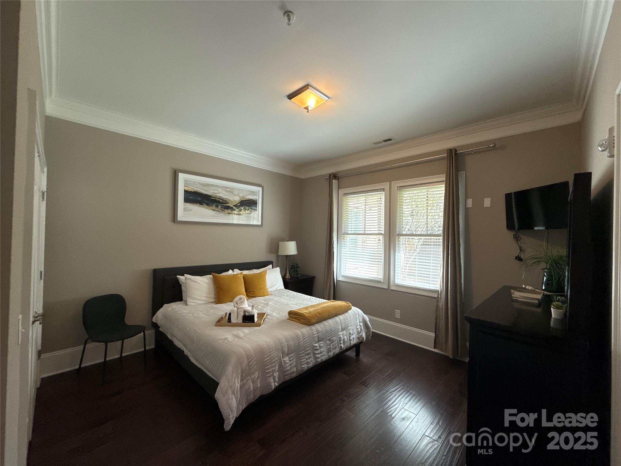 13931 Thompson Road Charlotte, NC 28227 - Photo 26 of 41 a bedroom with a bed and wooden floor