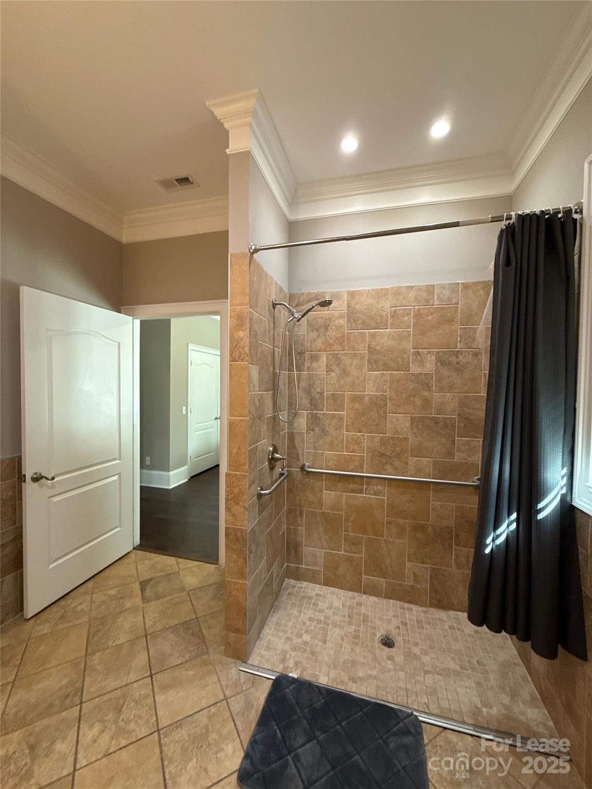 13931 Thompson Road Charlotte, NC 28227 - Photo 28 of 41 a bathroom with a glass shower door