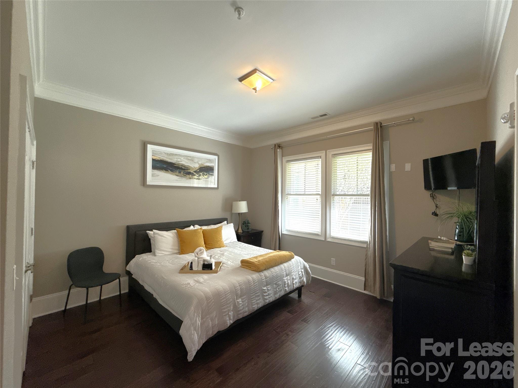 13931 Thompson Road Charlotte, NC 28227 - Photo 28 of 43 a bedroom with a bed and wooden floor