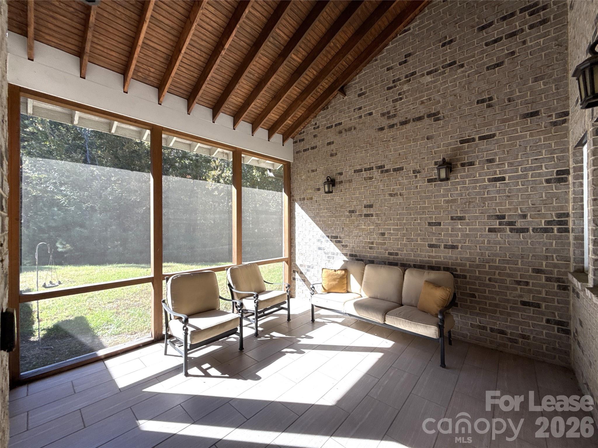 13931 Thompson Road Charlotte, NC 28227 - Photo 40 of 43 a living room with patio furniture and a floor to ceiling window