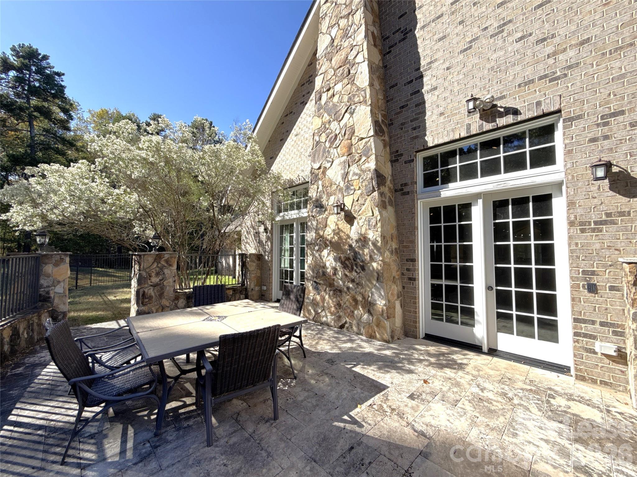 13931 Thompson Road Charlotte, NC 28227 - Photo 41 of 43 a view of a dinning table and chairs in the patio