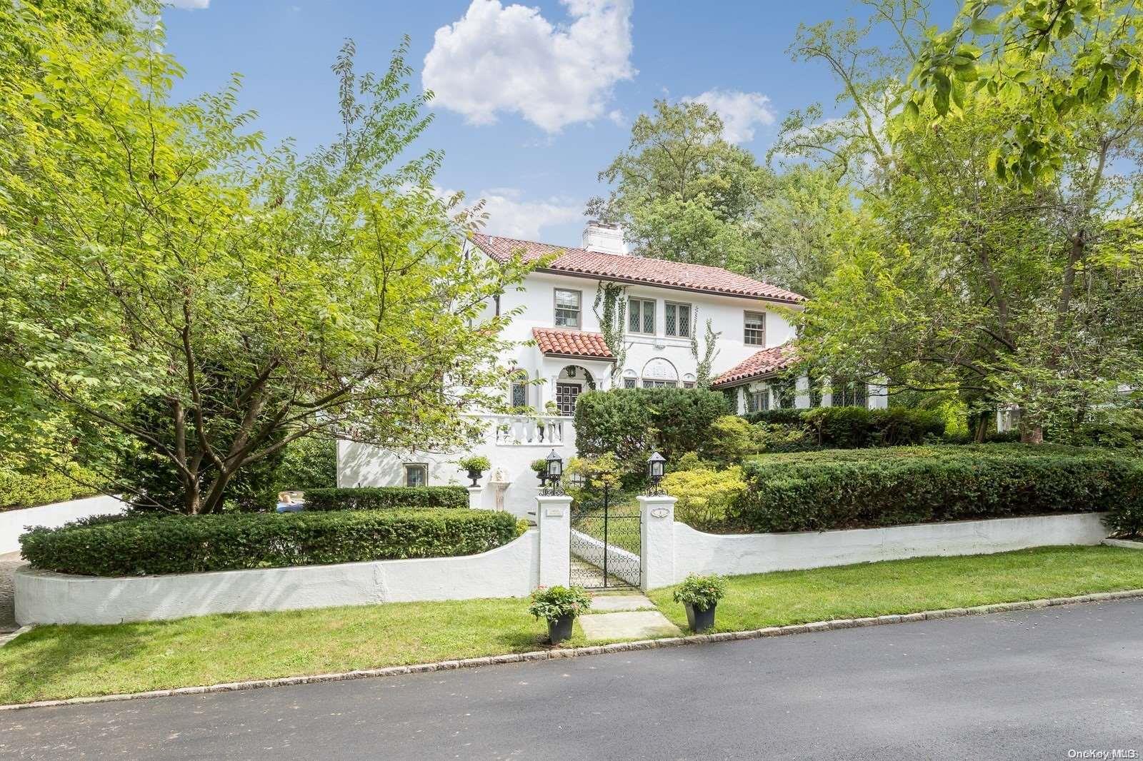 a front view of a house with a yard garage and outdoor seating