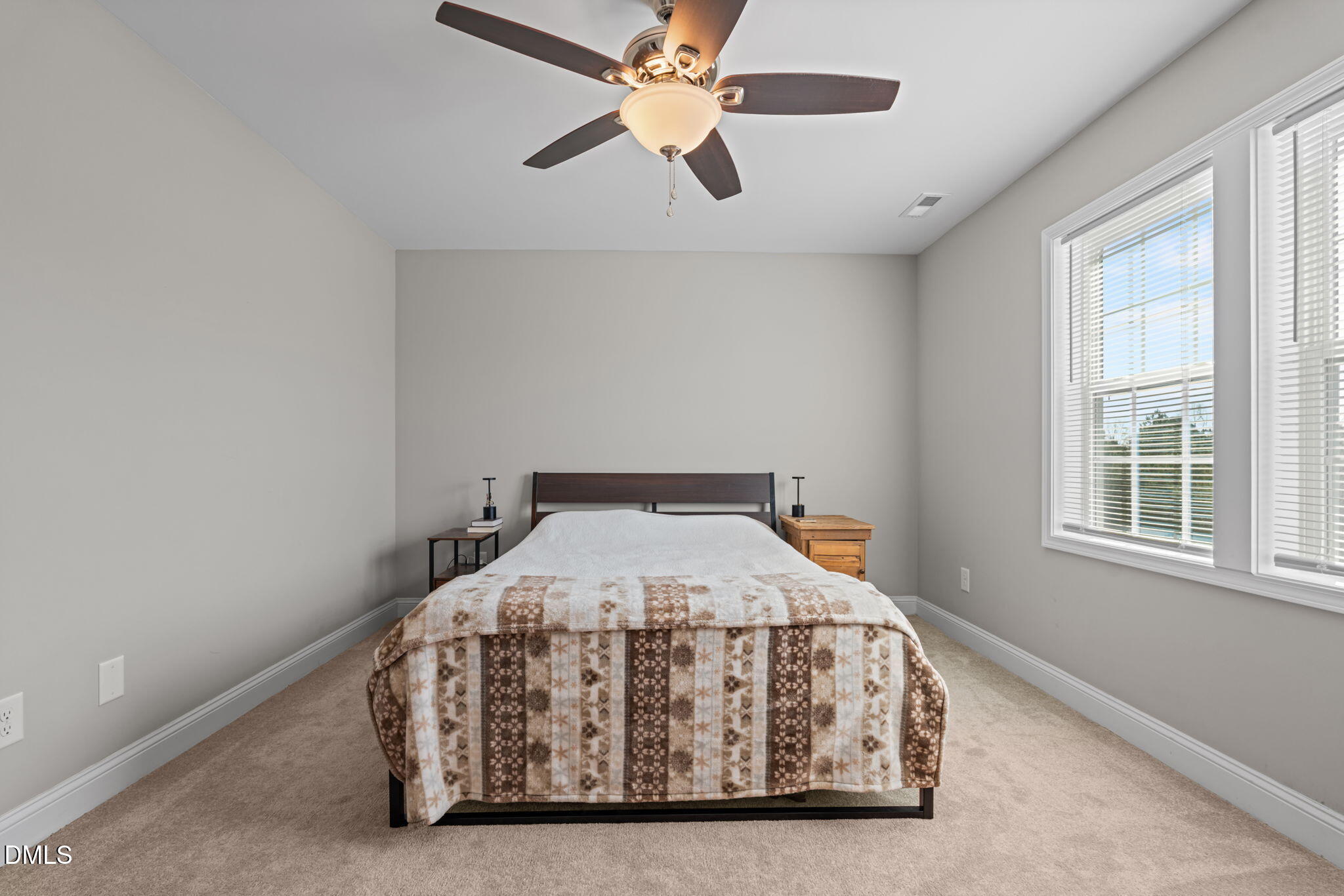 904 Allstar Avenue Cameron, NC 28326 - Photo 20 of 34 a bedroom with a bed and a chandelier