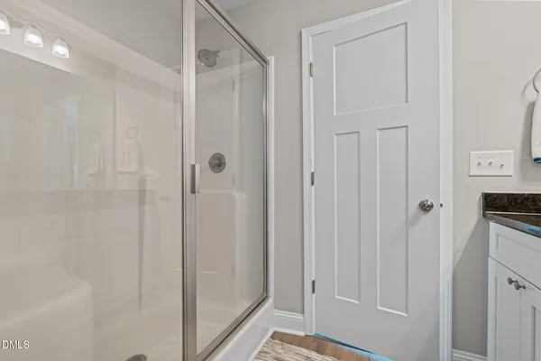 a bathroom with a shower and a door