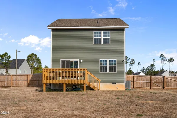 a view of a house with a wooden fence