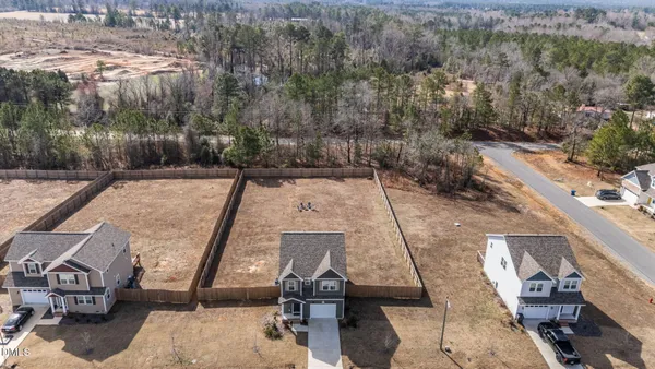 an aerial view of a house with a yard