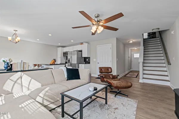 a living room with furniture and wooden floor