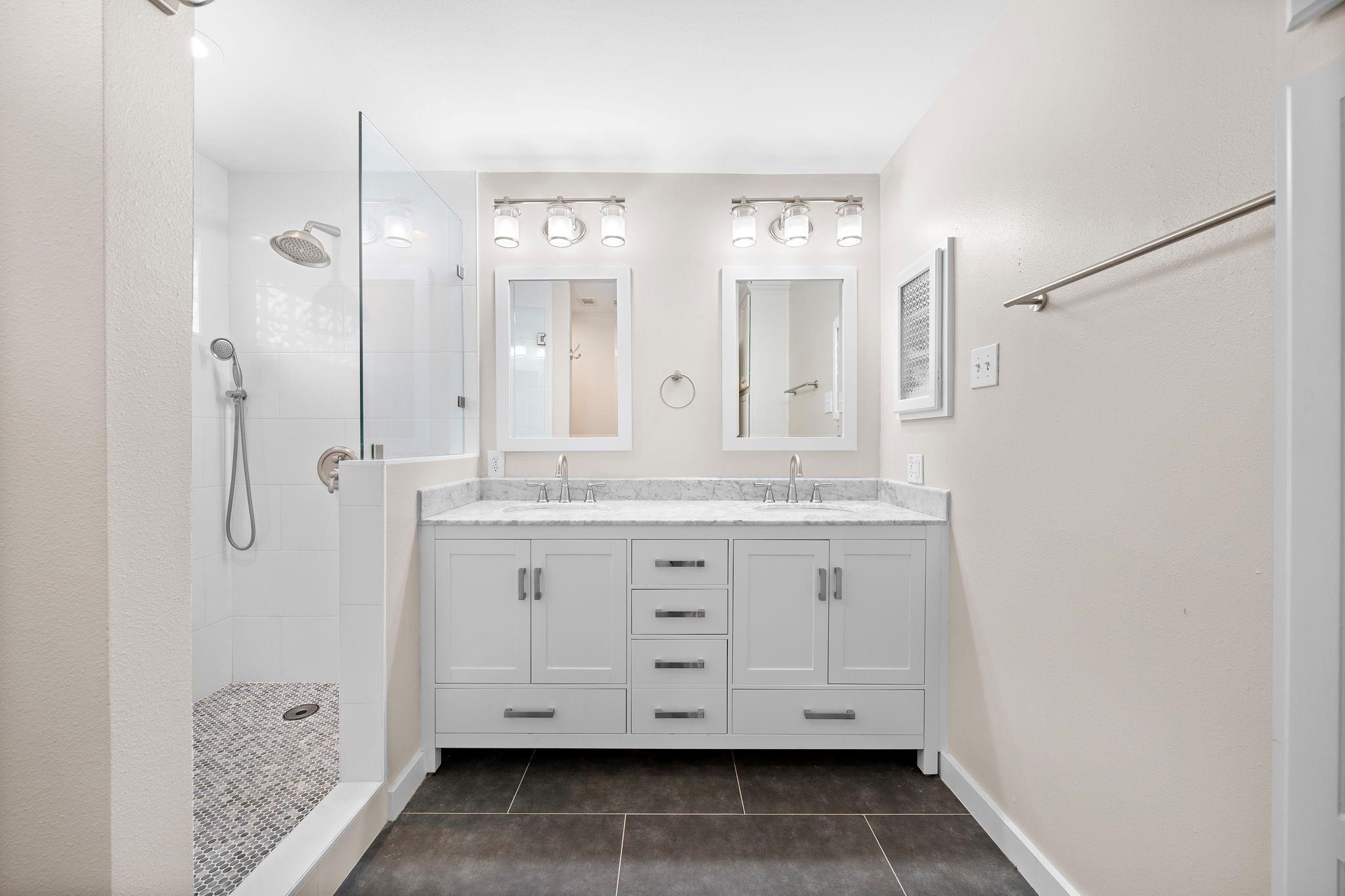 954 West 41st Street Houston, TX 77018 - Photo 13 of 19 a bathroom with a granite countertop sink two mirror and shower