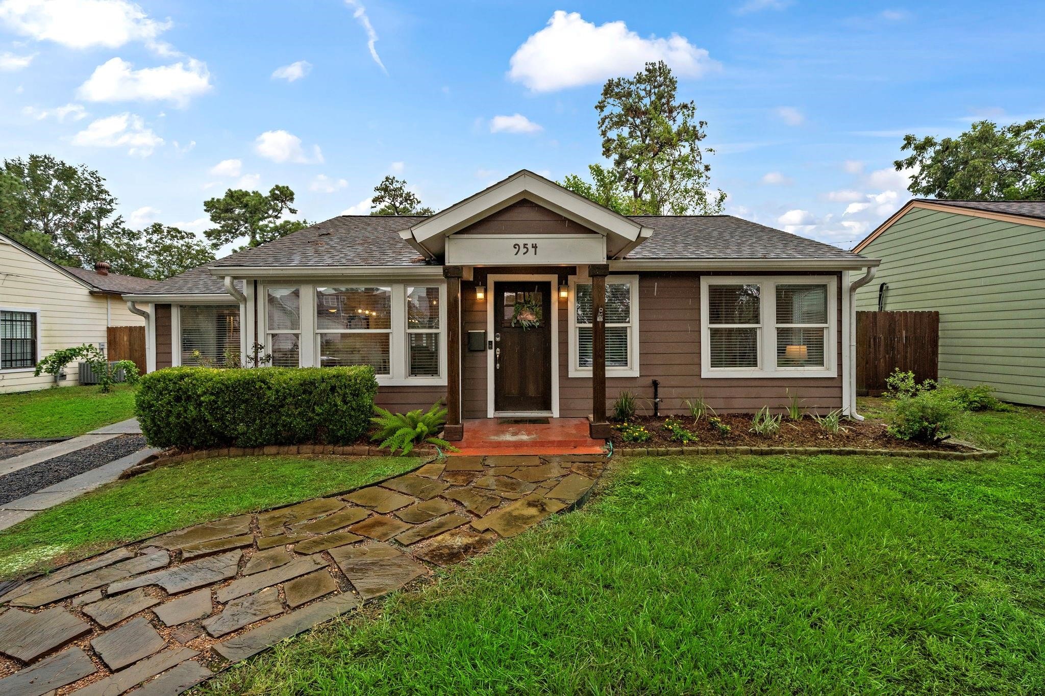 954 West 41st Street Houston, TX 77018 - Photo 2 of 19 a front view of a house with a yard and garage