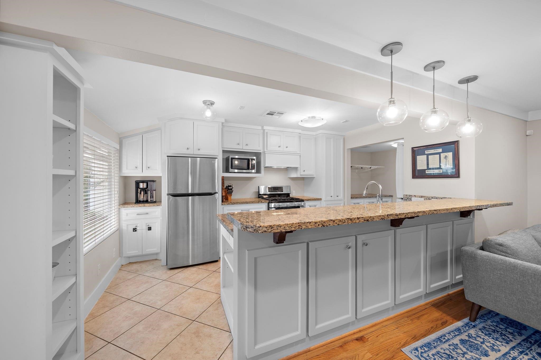 954 West 41st Street Houston, TX 77018 - Photo 6 of 19 a kitchen with white cabinets and refrigerator