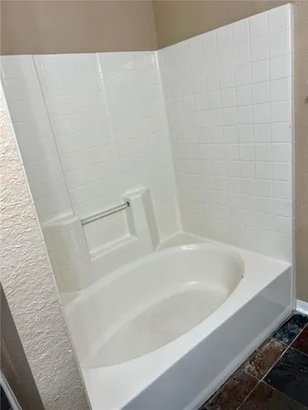 a white bath tub sitting next to a white sink