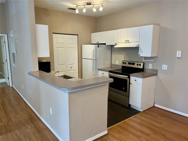 a kitchen with a stove and a refrigerator