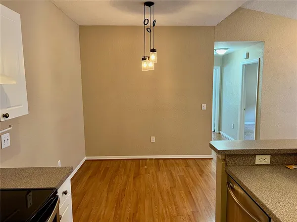 a view of a room with wooden floor and cabinet