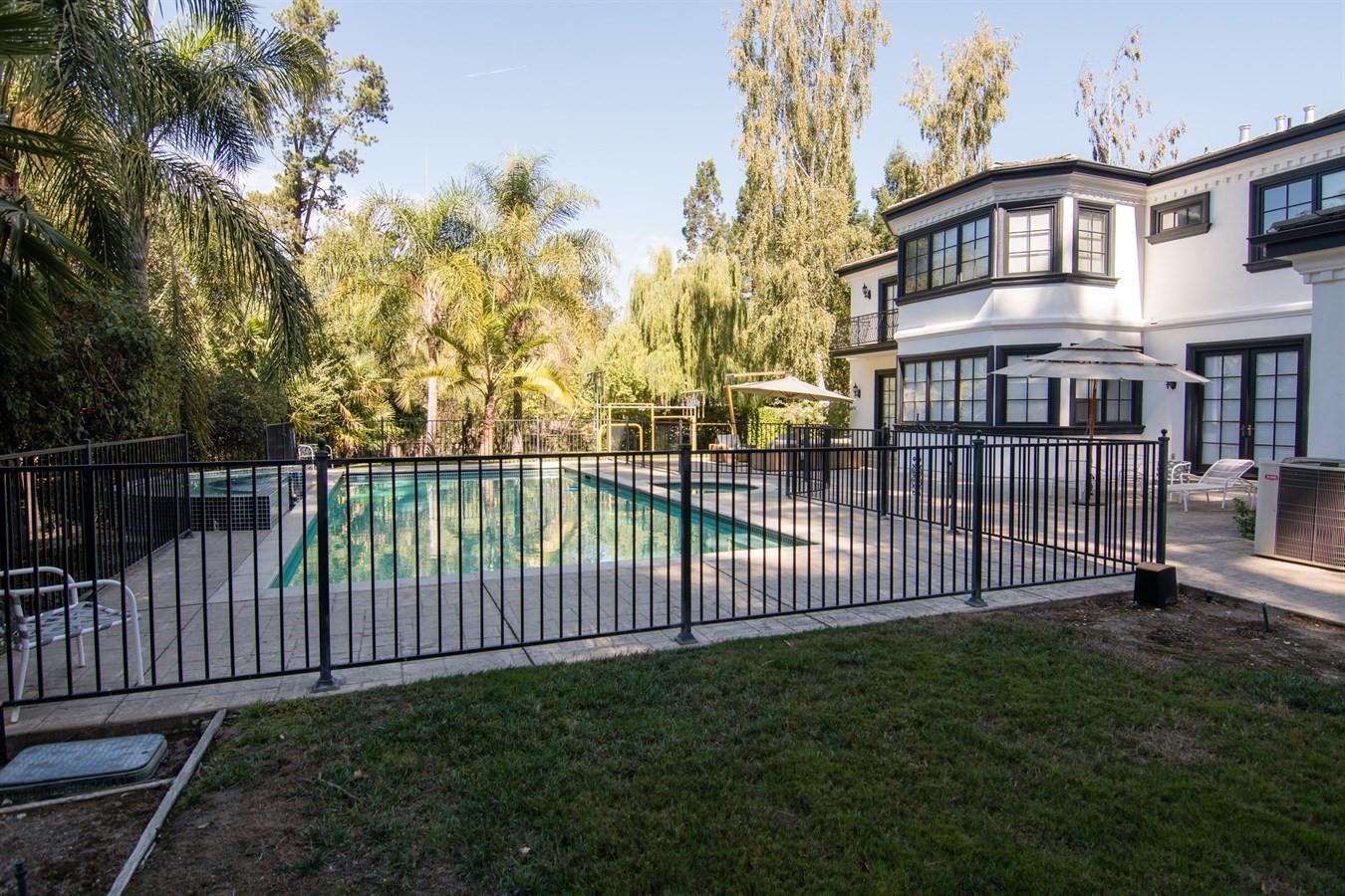 37 Valley Road Atherton, CA 94027 - Photo 25 of 26 a view of a white house with a small yard and large trees