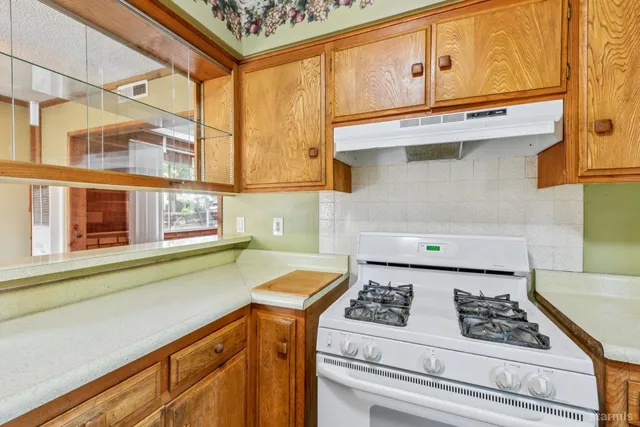 a kitchen with stainless steel appliances granite countertop a sink and a stove