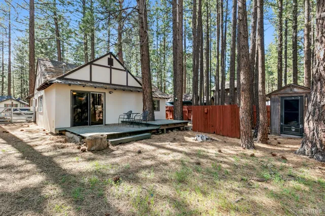 a view of a house with backyard and sitting area