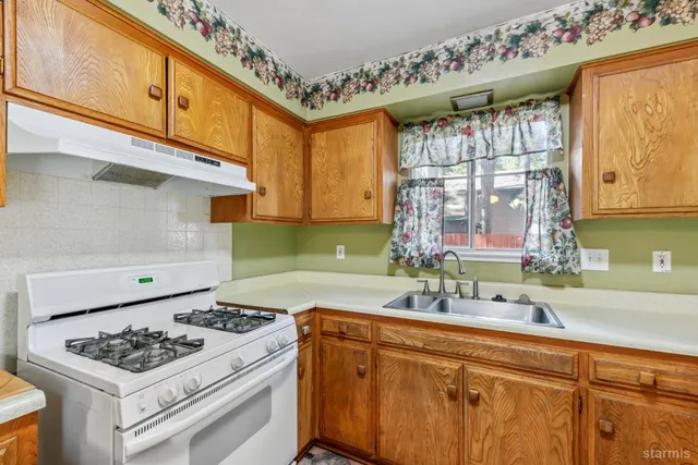 a kitchen with a stove and a sink