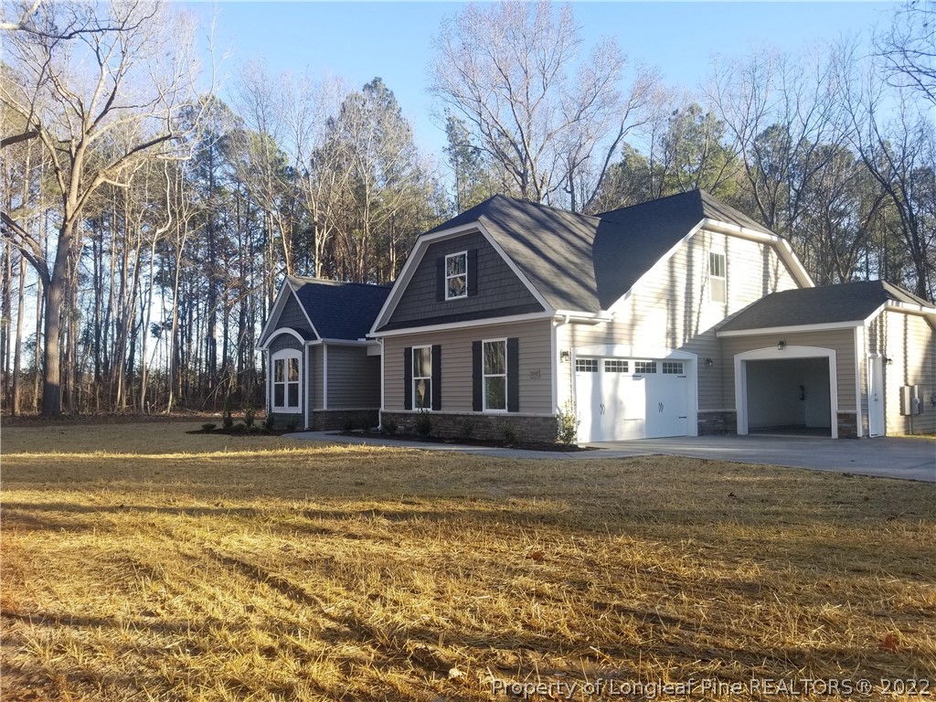 5090 J T Matthews Road Godwin, NC 28344 - Photo 4 of 7 a front view of a house with a yard