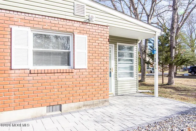 a view of a brick house with a door and wooden floor