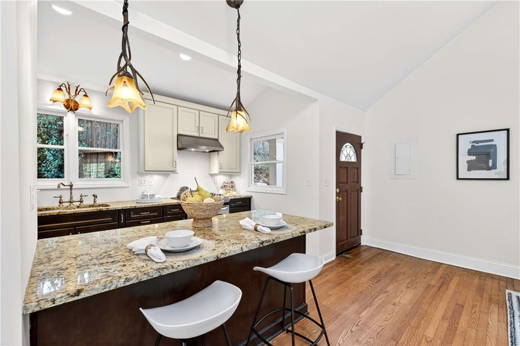 421 Emory Drive Northeast Atlanta, GA 30307 - Photo 15 of 42 a kitchen with a sink a stove and chairs