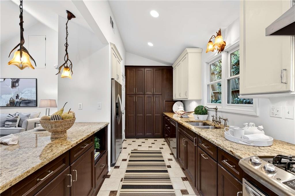 421 Emory Drive Northeast Atlanta, GA 30307 - Photo 16 of 42 a kitchen with a sink stove and cabinets
