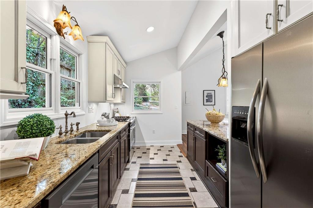 421 Emory Drive Northeast Atlanta, GA 30307 - Photo 17 of 42 a kitchen with granite countertop stainless steel appliances a sink stove and refrigerator