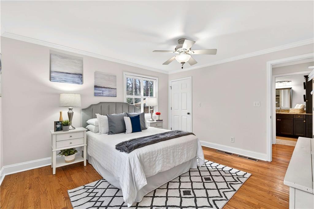 421 Emory Drive Northeast Atlanta, GA 30307 - Photo 24 of 42 a bedroom with a bed and a chandelier