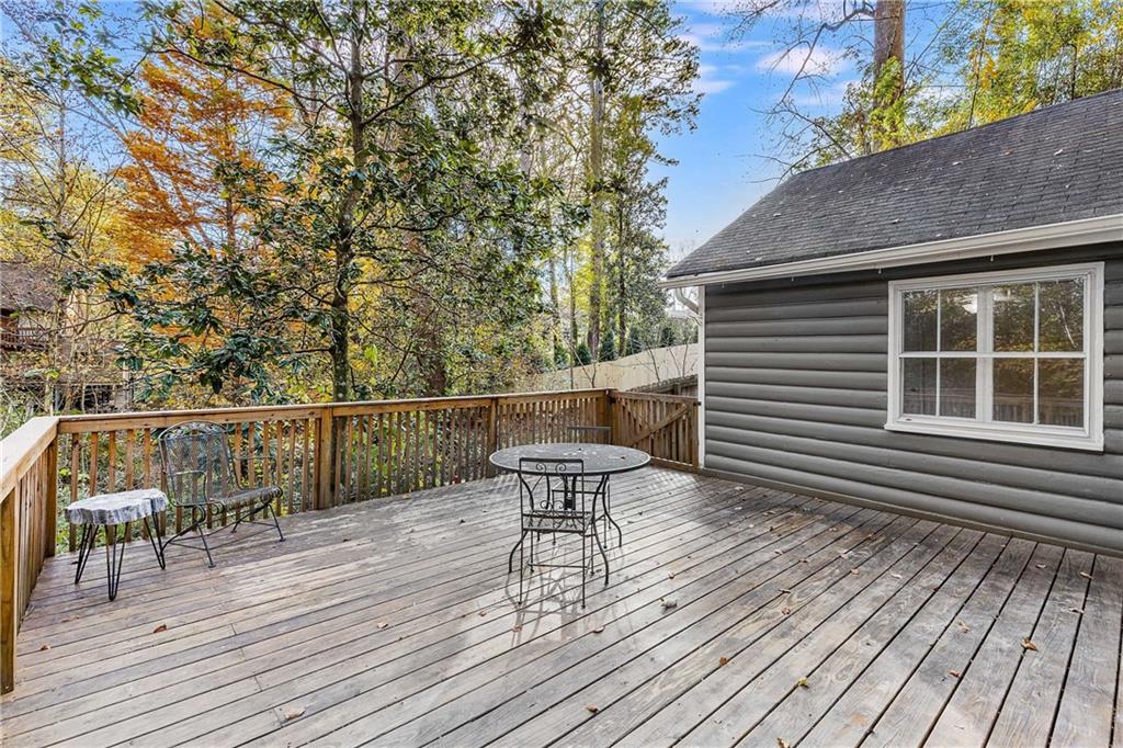 421 Emory Drive Northeast Atlanta, GA 30307 - Photo 30 of 42 a view of a roof deck with table and chairs and wooden floor